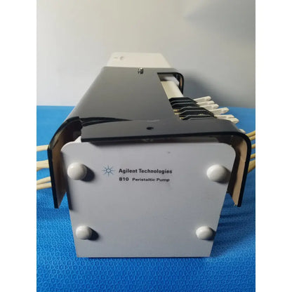 Agilent Technologies 810 peristaltic pump with gray and black metallic body and beige tubing connectors for reuse medical applications