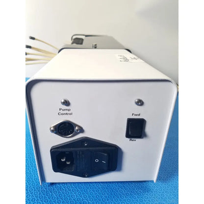White rectangular agilent technologies 810 peristaltic pump control unit with toggle switches for reuse medical applications
