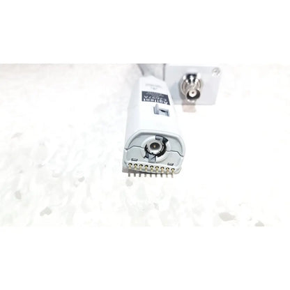 White plastic agilent technologies e2697a high impedance adapter with metallic pins and circular port labeled adapti