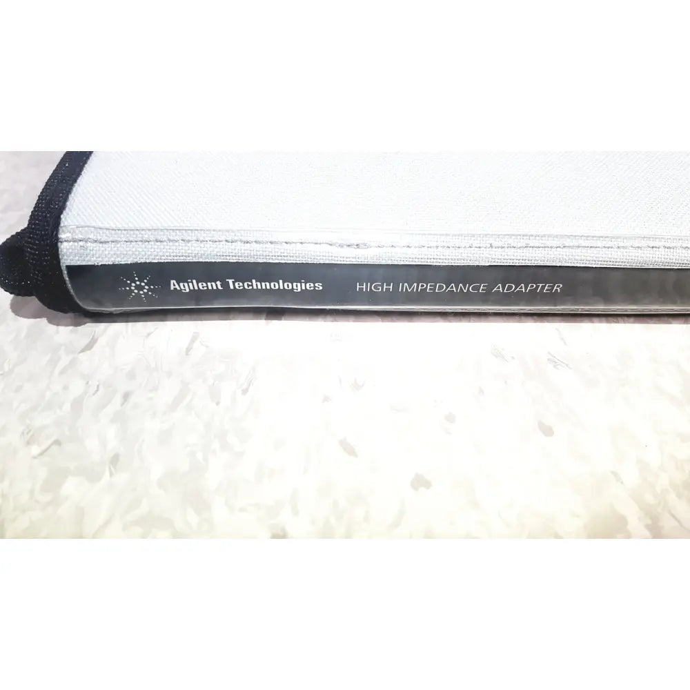 Agilent Technologies e2697a high impedance adapter in black and white housed in a protective fabric sleeve with reinforced stitching