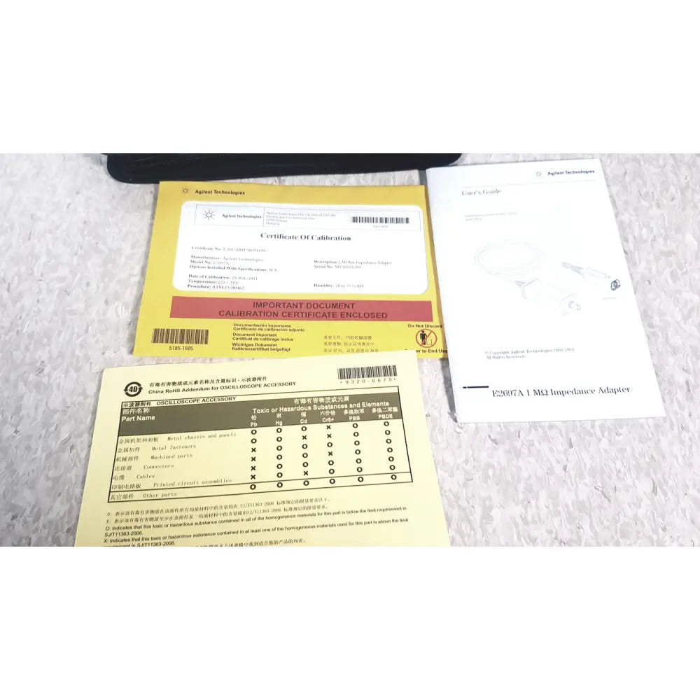 Yellow certificate of calibration for agilent technologies e2697a high impedance adapter with papers