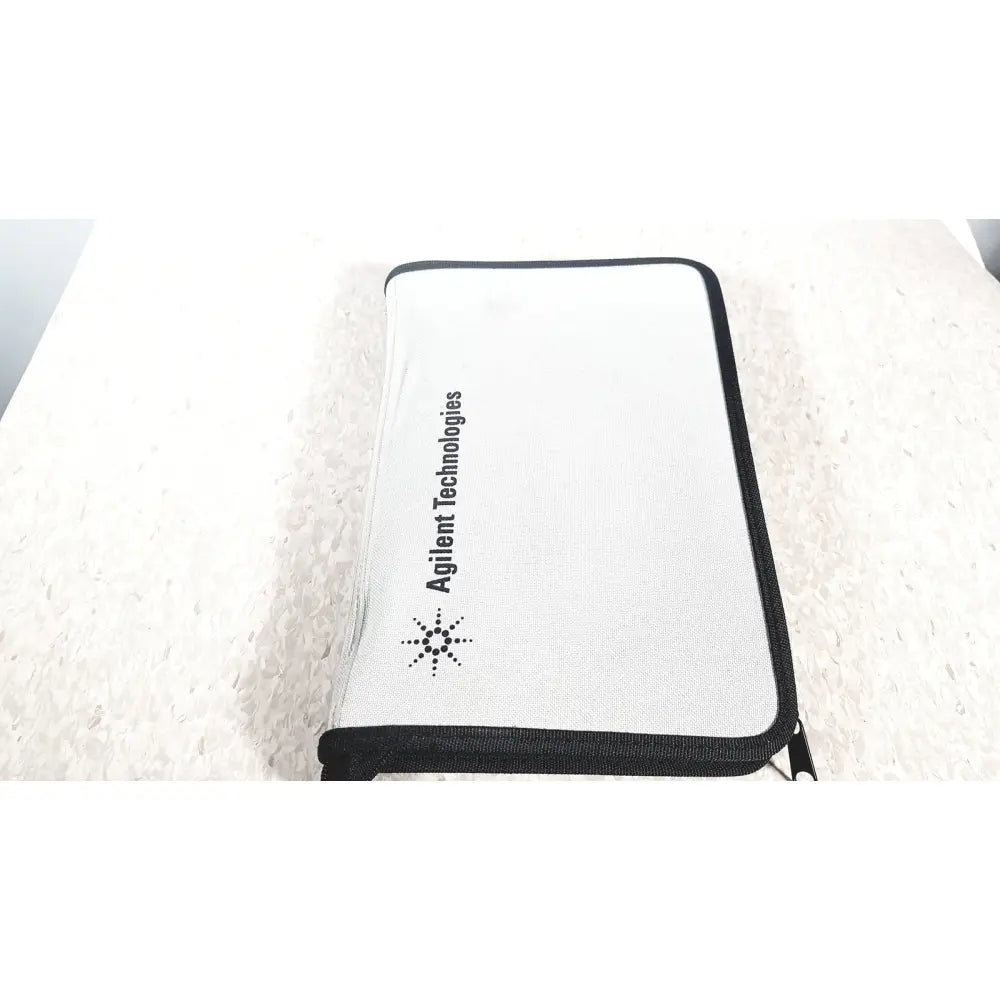 White zippered pouch with black trim and agilent technologies e2697a branding for high impedance adapter papers
