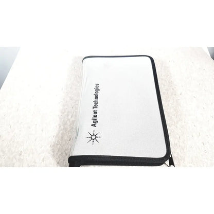White zippered pouch with black trim and agilent technologies e2697a branding for high impedance adapter papers