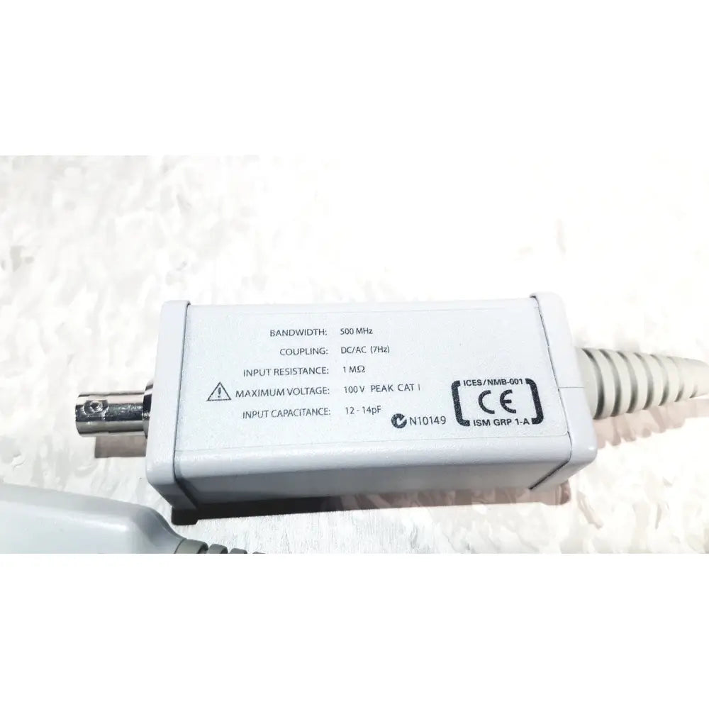 White rectangular electronic signal coupling unit with silver BNC connector and coiled cable agilent technologies e2697a high impedance adapter