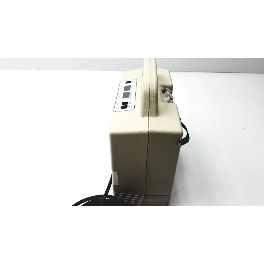 Beige portable oxygen concentrator with handle and control panel for aircast venaflow 30a vascular system use