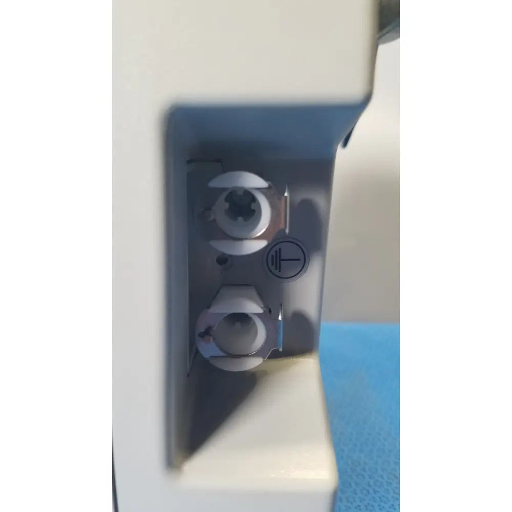 White plastic aircast venaflow elite dvt prophylaxis pump model 30bs back with two metal connectors and power symbol label