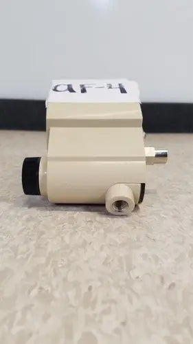 Beige industrial airco vacuum regulator pressure sensor with black and brass fittings for precise vacuum control