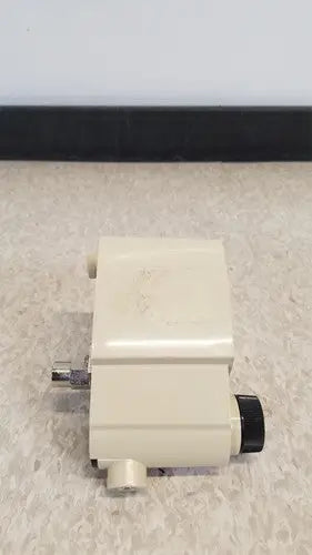 Cream-colored plastic airco vacuum regulator with black knob and metallic fittings for precise airco vacuum control