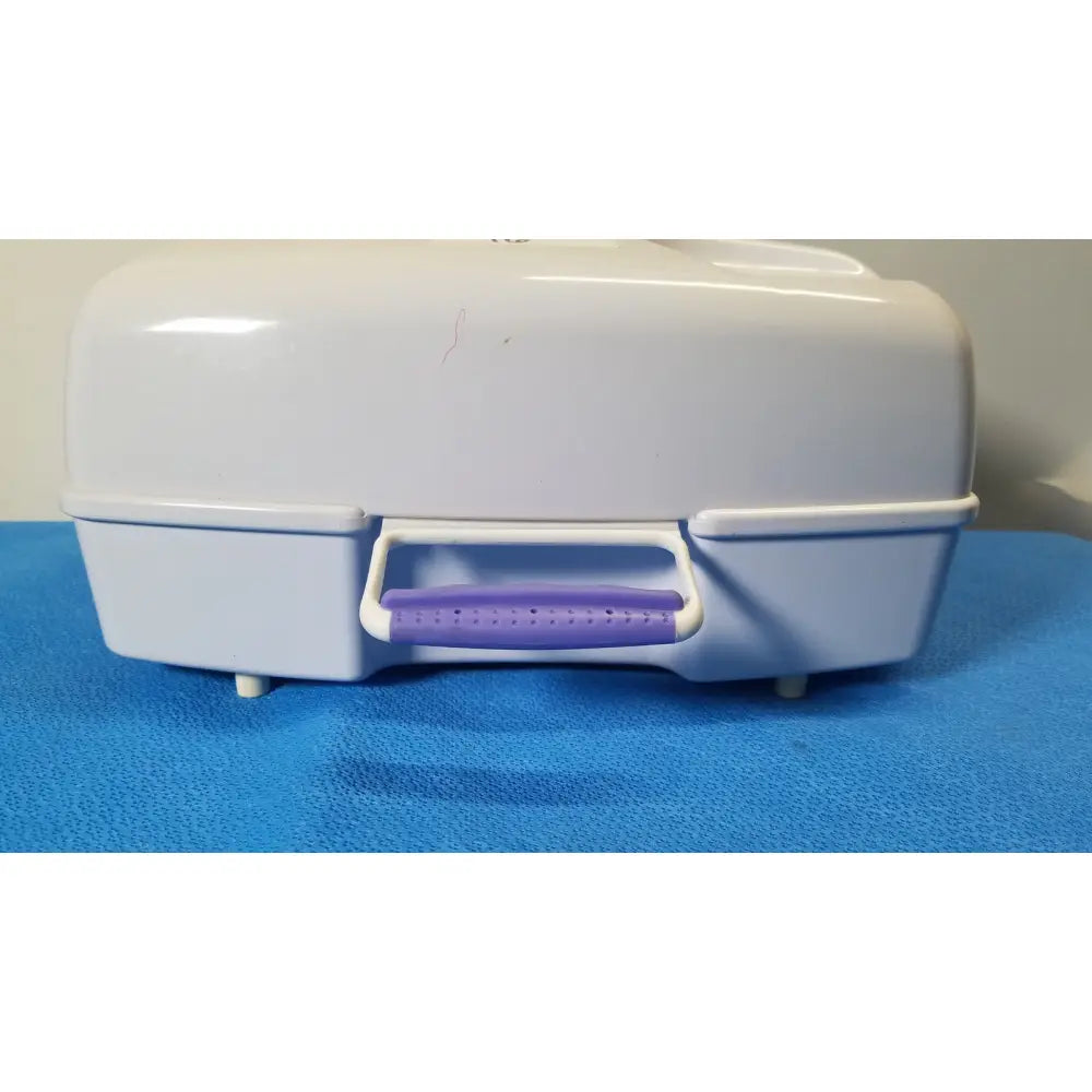 White plastic airflo bathing cushion storage case with purple perforated handle for cushion air compressor use