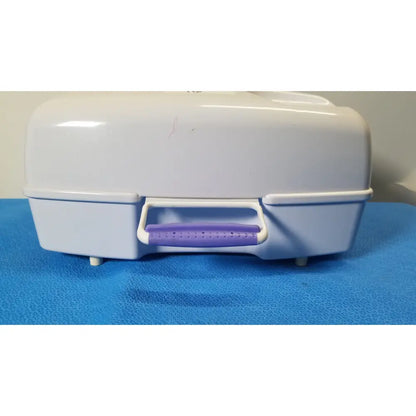 White plastic airflo bathing cushion storage case with purple perforated handle for cushion air compressor use
