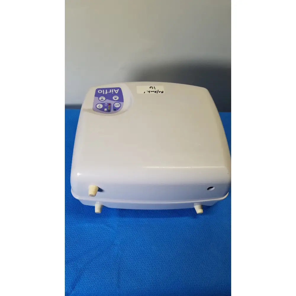 White plastic airflo bathing cushion air compressor with purple control panel and beige fittings for bathing cushion air