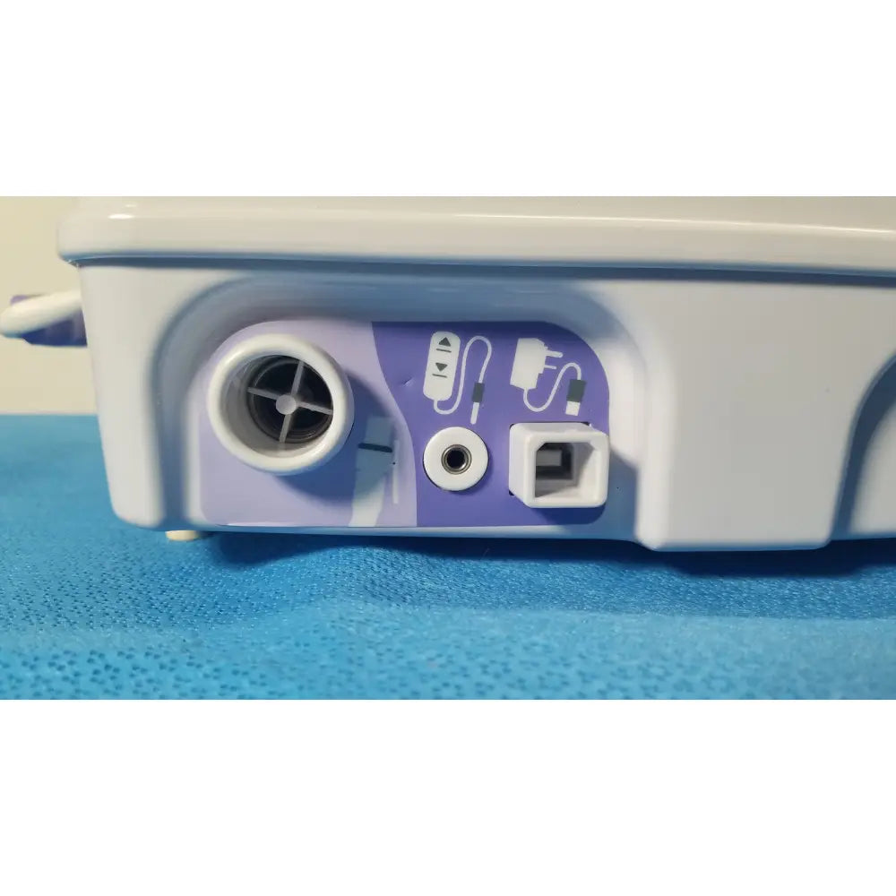 White and purple airflo bathing cushion air compressor back with circular air intake audio jack and rectangular port