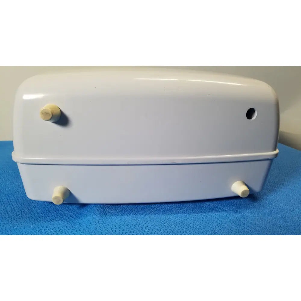 White plastic pet carrier with rounded edges and beige rubber feet for airflo bathing cushion air compressor use