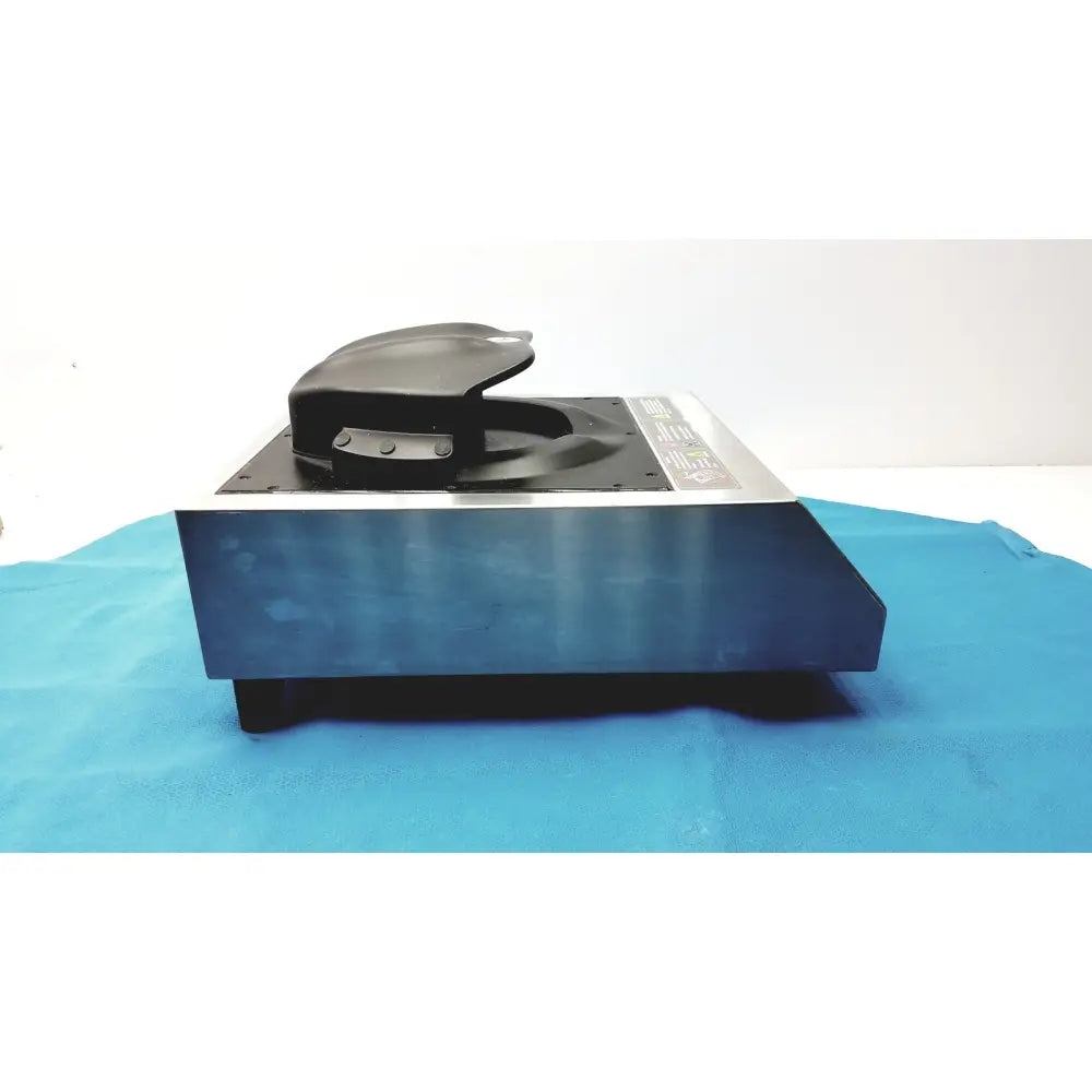 Black plastic shoe shine machine with silver metallic base and black foot pedal in aladdin temp-rite heat demand advantage plate heater