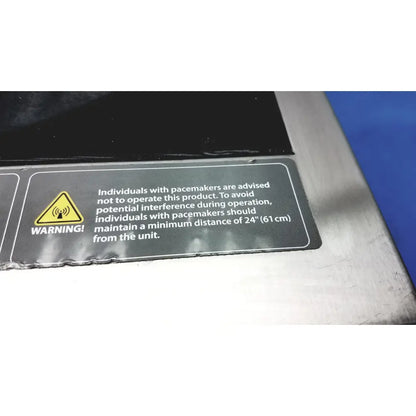 Black warning label on aladdin temp-rite heat on demand advantage rs plus plate heater advising 24-inch distance for pacemakers