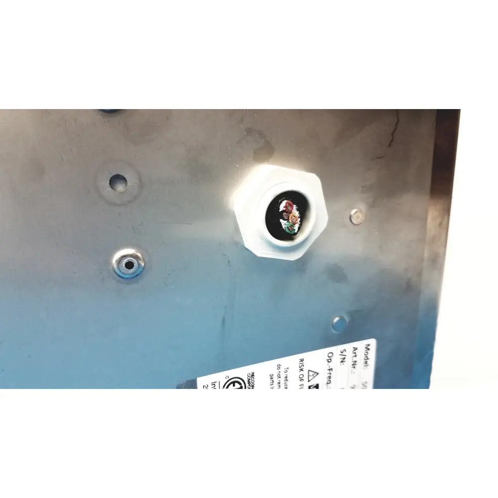 White hexagonal cable gland securing multicolored wires on metallic surface of aladdin temp-rite heat on demand advantage plate heater