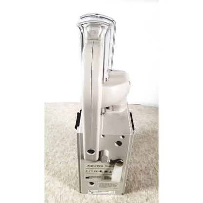 White alaris pca model 9 portable medical device with clear plastic handle and metallic accents for infusion therapy