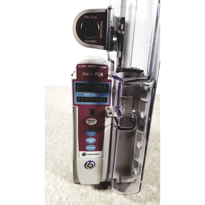 Maroon and silver alariis pca model 8120 infusion pump with transparent medication bag attached without keys