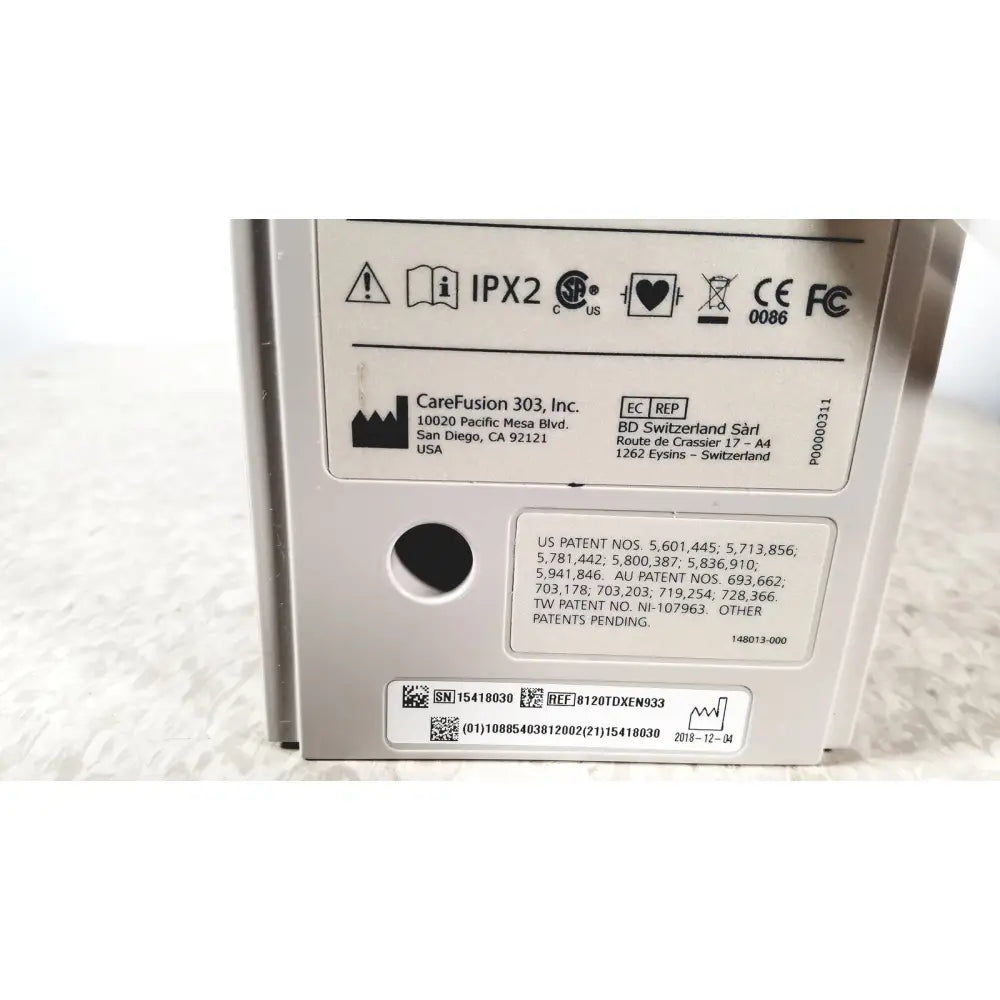 Back side of a silver metallic alariis pca model 8120 medical device with carefusion 303 inc label and regulatory info
