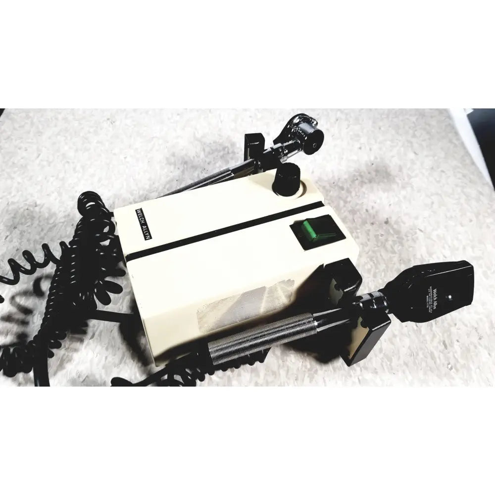 Cream-colored medical ophthalmoscope with black accents and coiled cord for alaris 8100 series pump module unit