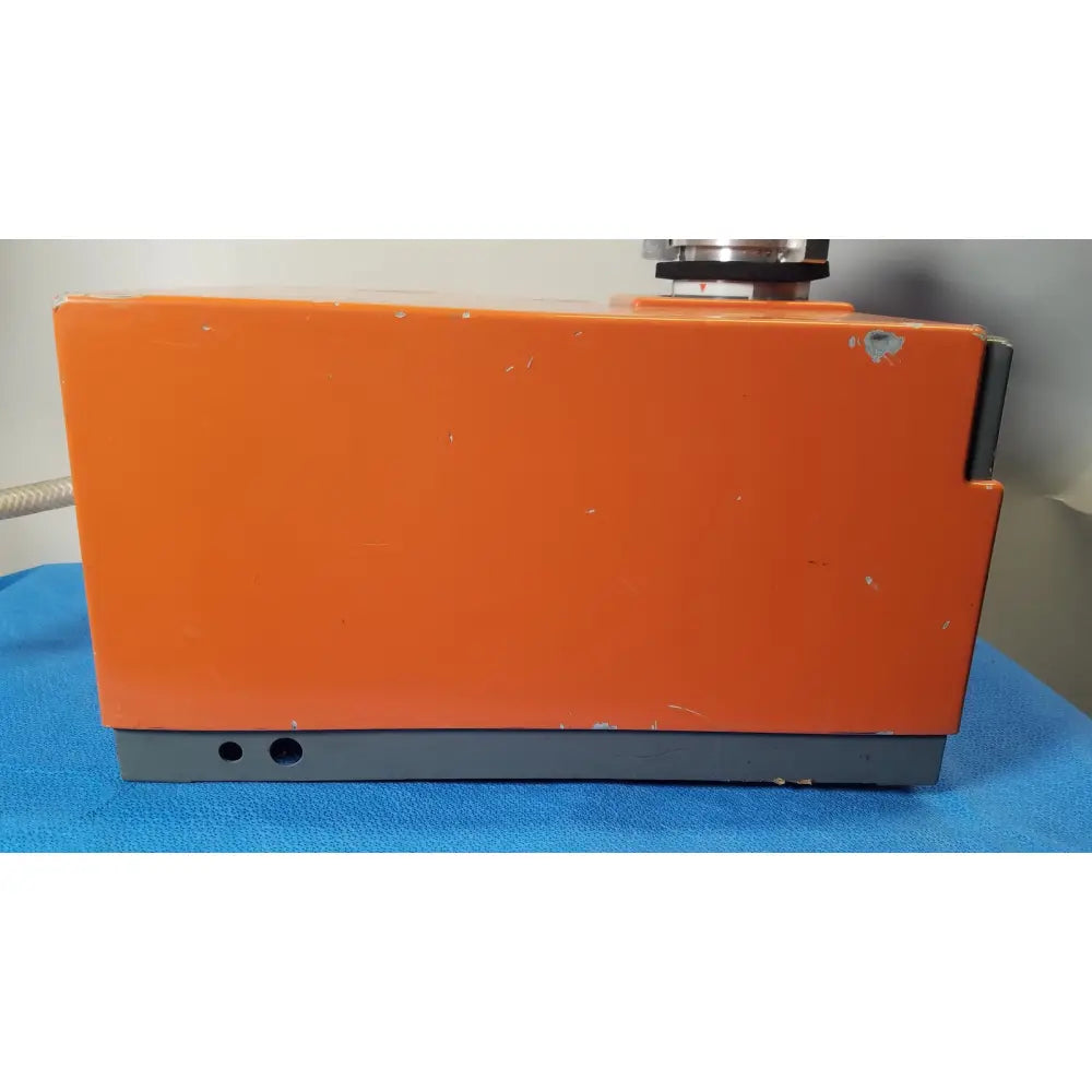 Orange rectangular alcatel drytel vacuum pump station with gray base and visible wear marks for industrial use