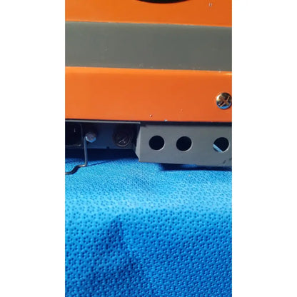 Orange and gray industrial alcatel drytel 31 vacuum pump station with metallic screw head as key feature