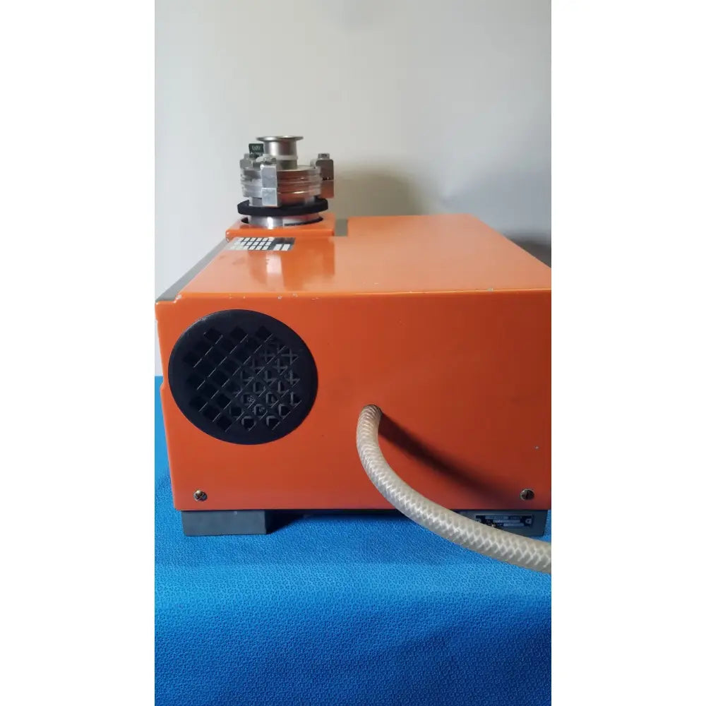 Orange alcatel drytel 31 vacuum pump station with black circular vent and metallic top component for industrial use