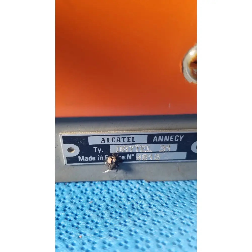 Orange alcatel drytel 31 vacuum pump station with metallic label and blue textured surface for vacuum pump use
