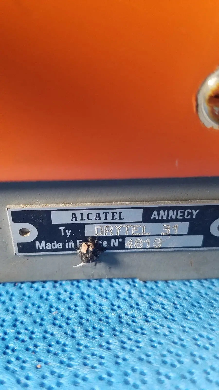 Orange alcatel drytel 31 vacuum pump station with metallic label and blue textured surface for vacuum pump use