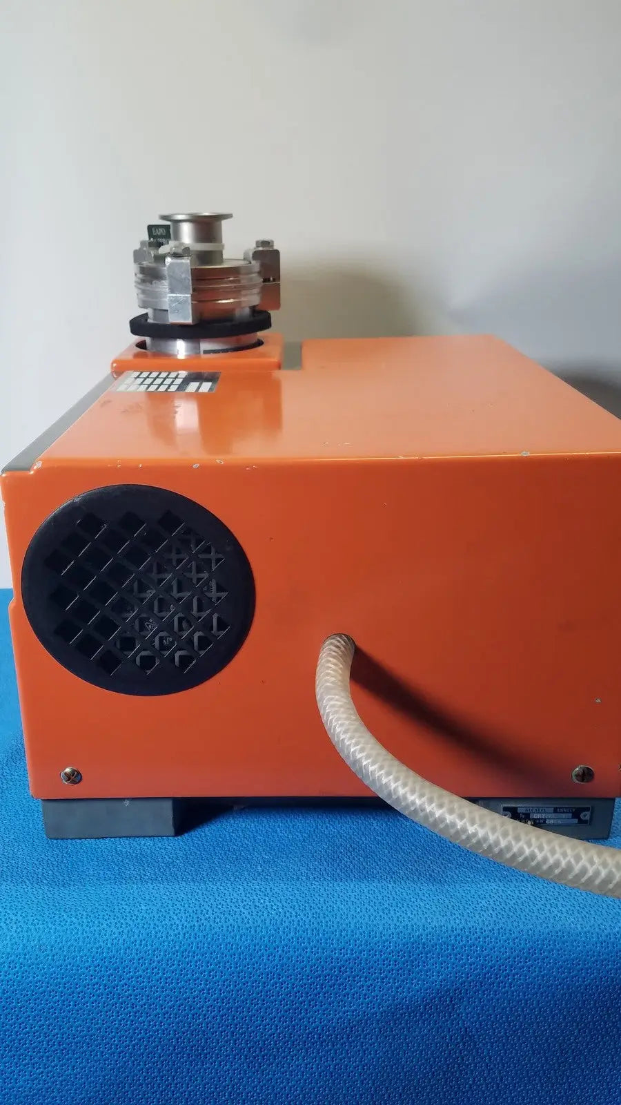 Orange alcatel drytel 31 vacuum pump station with black circular vent and metallic top component for industrial use