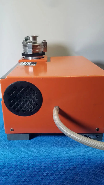 Orange alcatel drytel 31 vacuum pump station with black circular vent and metallic top component for industrial use