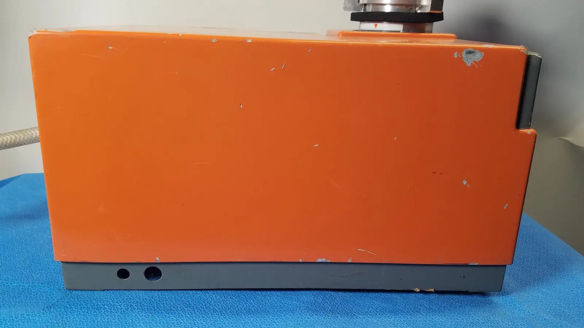 Orange rectangular alcatel drytel vacuum pump station with gray base and visible wear marks for industrial use