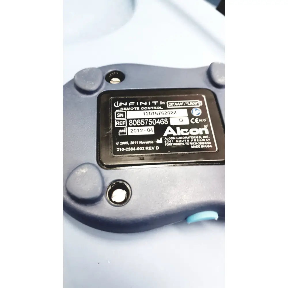 Black plastic remote control with matte finish and light blue accent for alcon infiniti vision phacoemulsification unit