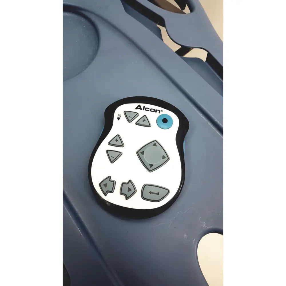 White alcon infiniti vision control panel with gray buttons and blue indicator light for phacoemulsification surgical unit