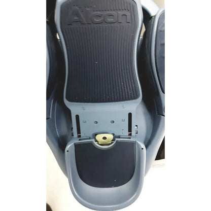 Gray Alcon Infiniti Vision system footrest with black textured rubber pads and adjustable sizing markings