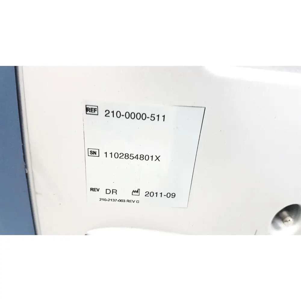 White rectangular label with black printed reference and serial numbers on the alcon infiniti vision system model 210-0000-511