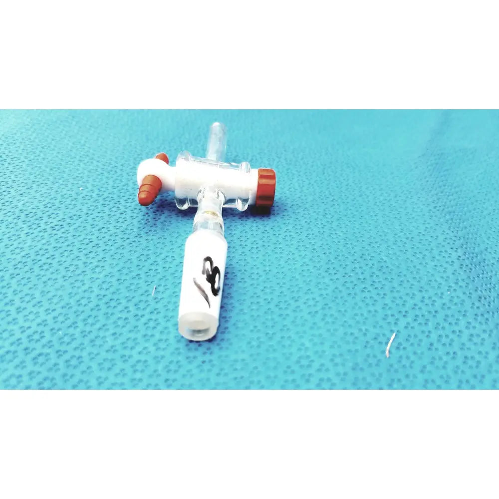 Clear plastic iv catheter with white and red caps paired with aldrich glass 14/20 ptfe bore septum inlet flow control adapter
