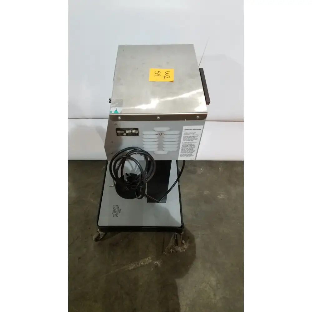 Stainless steel allied healthcare gomco 3040 aspirator with coiled black power cord and yellow price tag on top