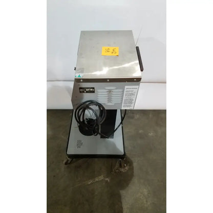 Stainless steel allied healthcare gomco 3040 aspirator with coiled black power cord and yellow price tag on top