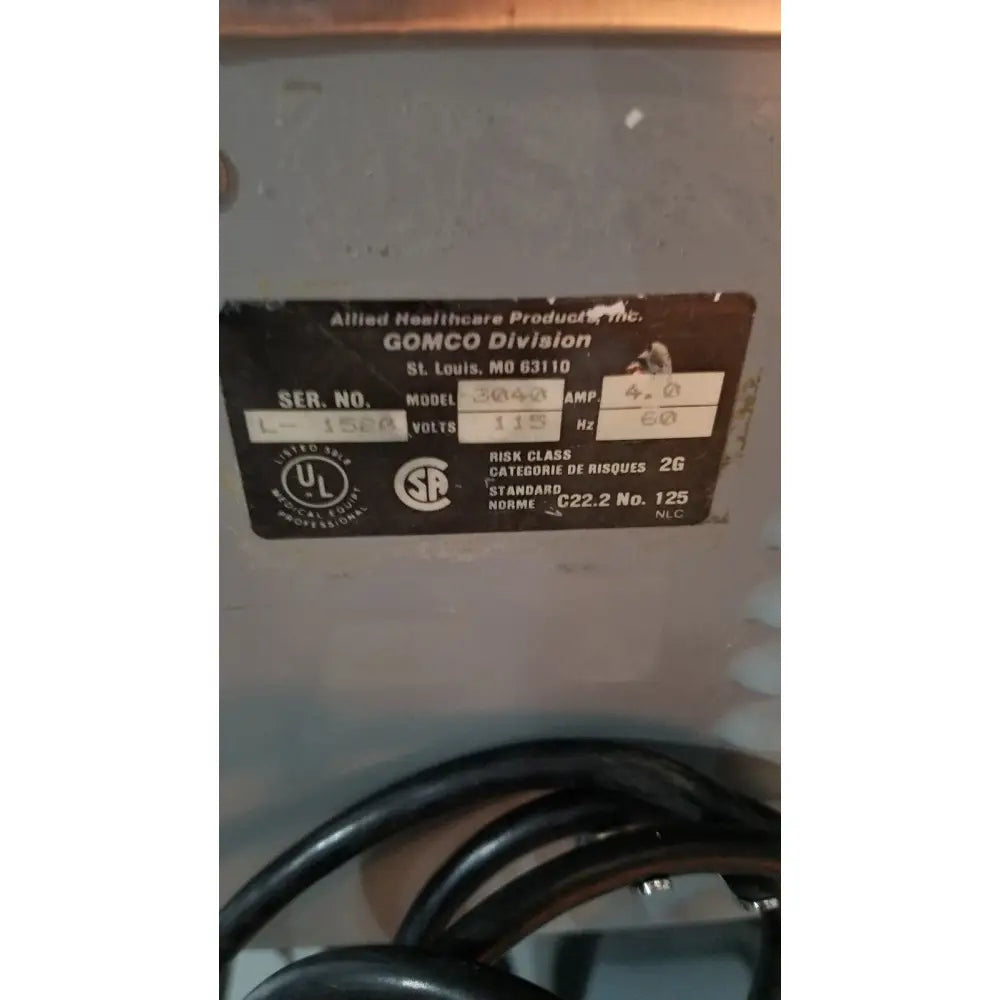 Black metal label with white text showing reuse medical specifications for allied healthcare gomco 3040 aspirator product