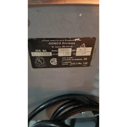 Black metal label with white text showing reuse medical specifications for allied healthcare gomco 3040 aspirator product