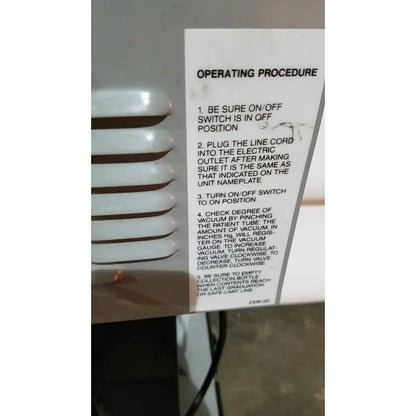 White paper label with black text on allied healthcare gomco 3040 aspirator showing operating procedure for reuse medical device