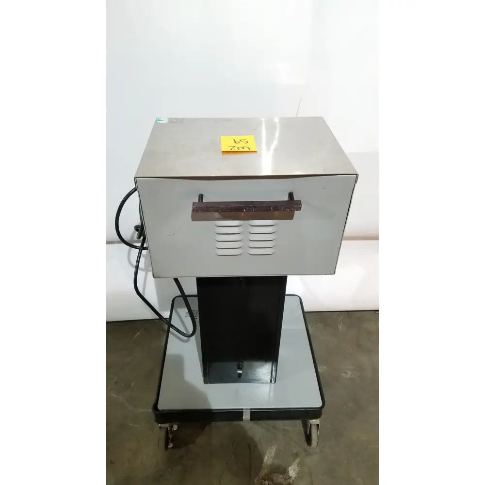 Silver stainless steel allied healthcare gomco 3040 aspirator coffee machine with black handle on wheeled cart for reuse medical use