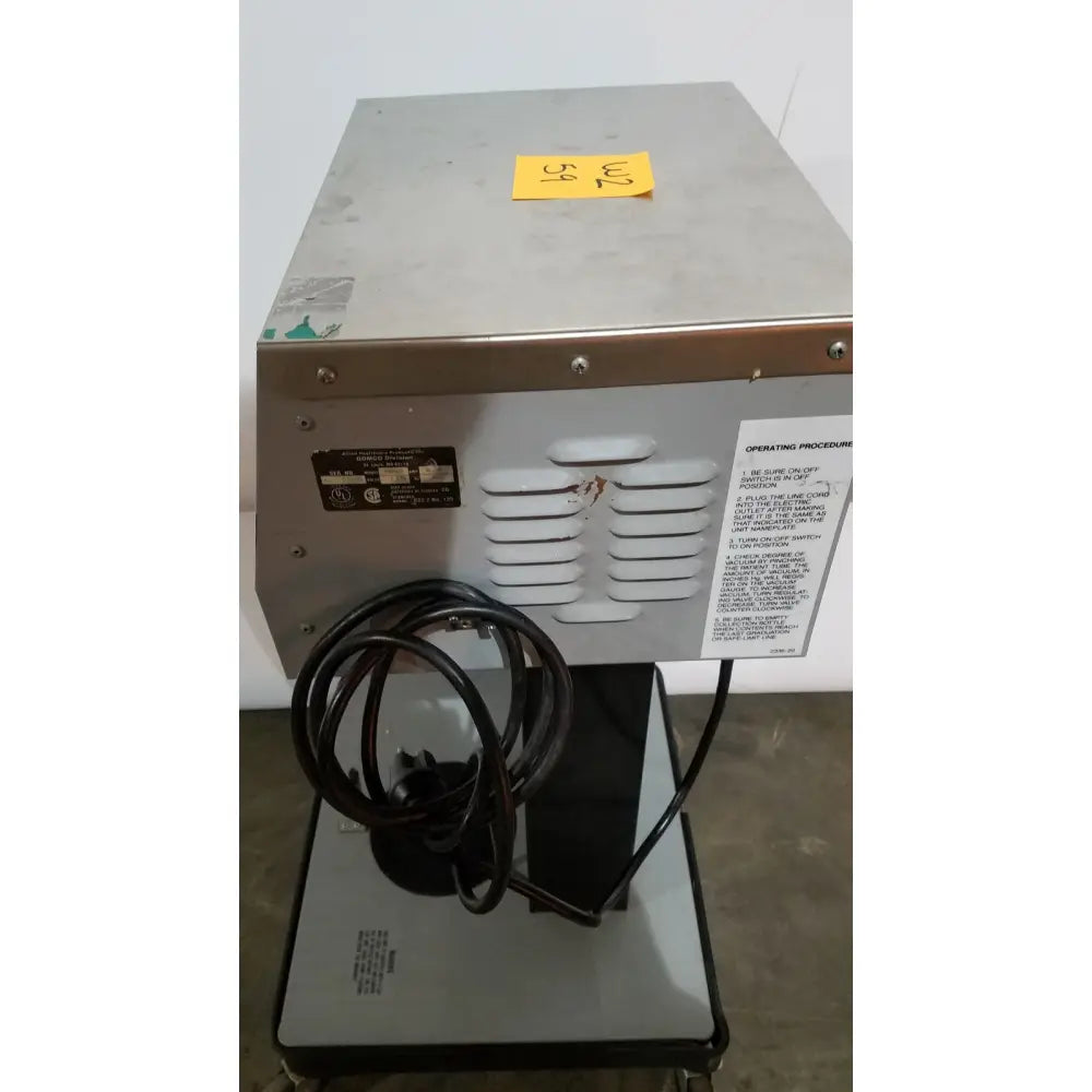 Industrial-grade stainless steel allied healthcare gomco 3040 aspirator back panel with ventilation slats and black power cord