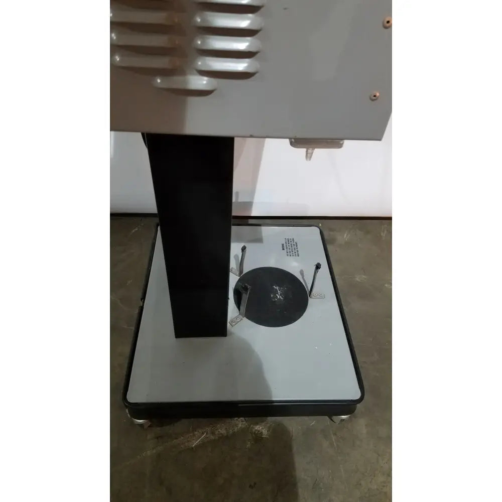 Gray and black allied healthcare gomco 3040 aspirator with vertical column, circular platform, and ventilation slats on top