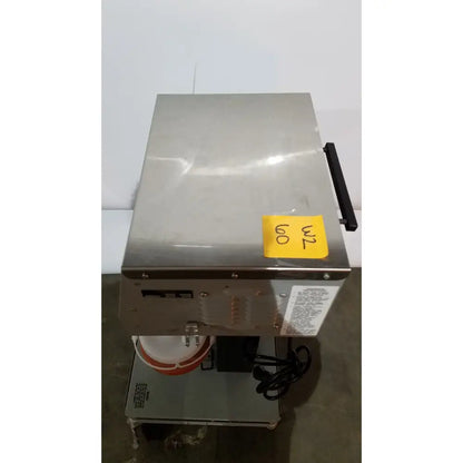 Stainless steel allied healthcare gomco aspirator model 6037 with black handle and yellow price tag visible
