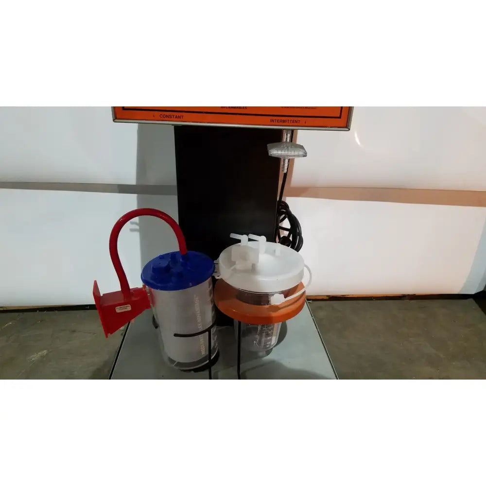 Allied healthcare gomco model 6037 aspirator showing silver blue medical suction canister with red handle and white orange canister