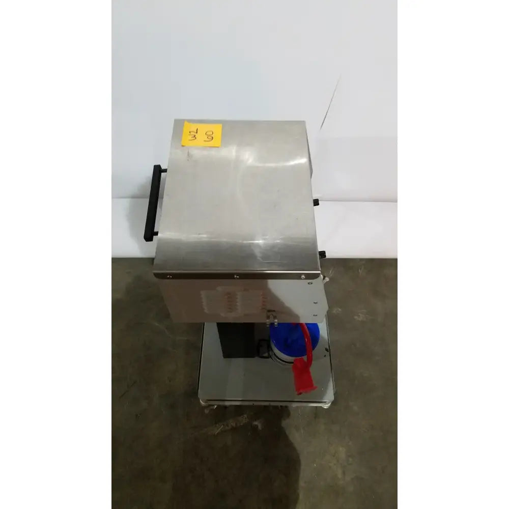 Stainless steel allied healthcare gomco model 6037 industrial food processor with black handle and blue container attached