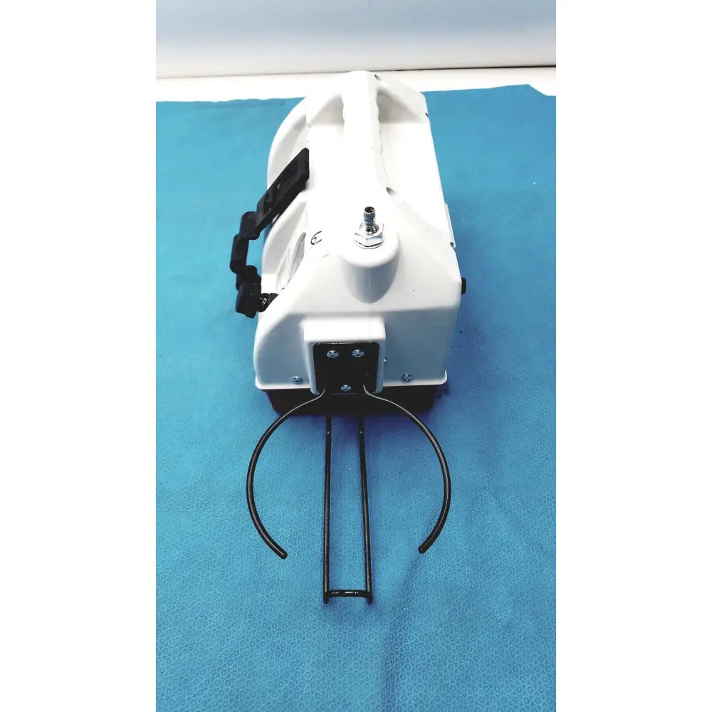 White plastic handheld allied healthcare gomco optivac g180 portable aspirator with black metal handle and cup holder