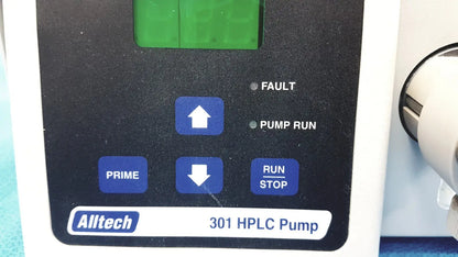 Alltech 301 pump hplc laboratory chromatography unit with black control panel and blue function buttons above green display